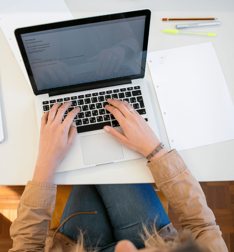 woman typing on a laptop