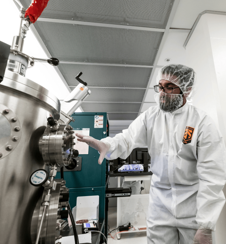researcher in lab in sanitation gear