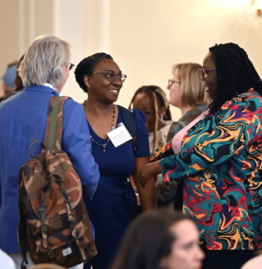 Pitt staff speaking to one another at the 2024 Pitt Research Internal Funding Showcase