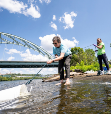 Emily Elliot in river doing research
