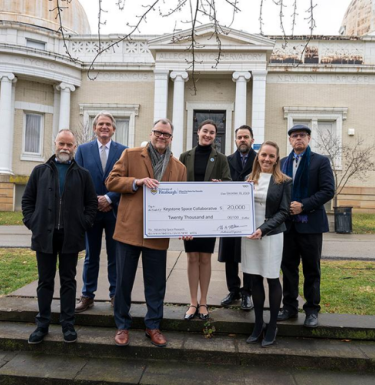 Pitt members accepting check